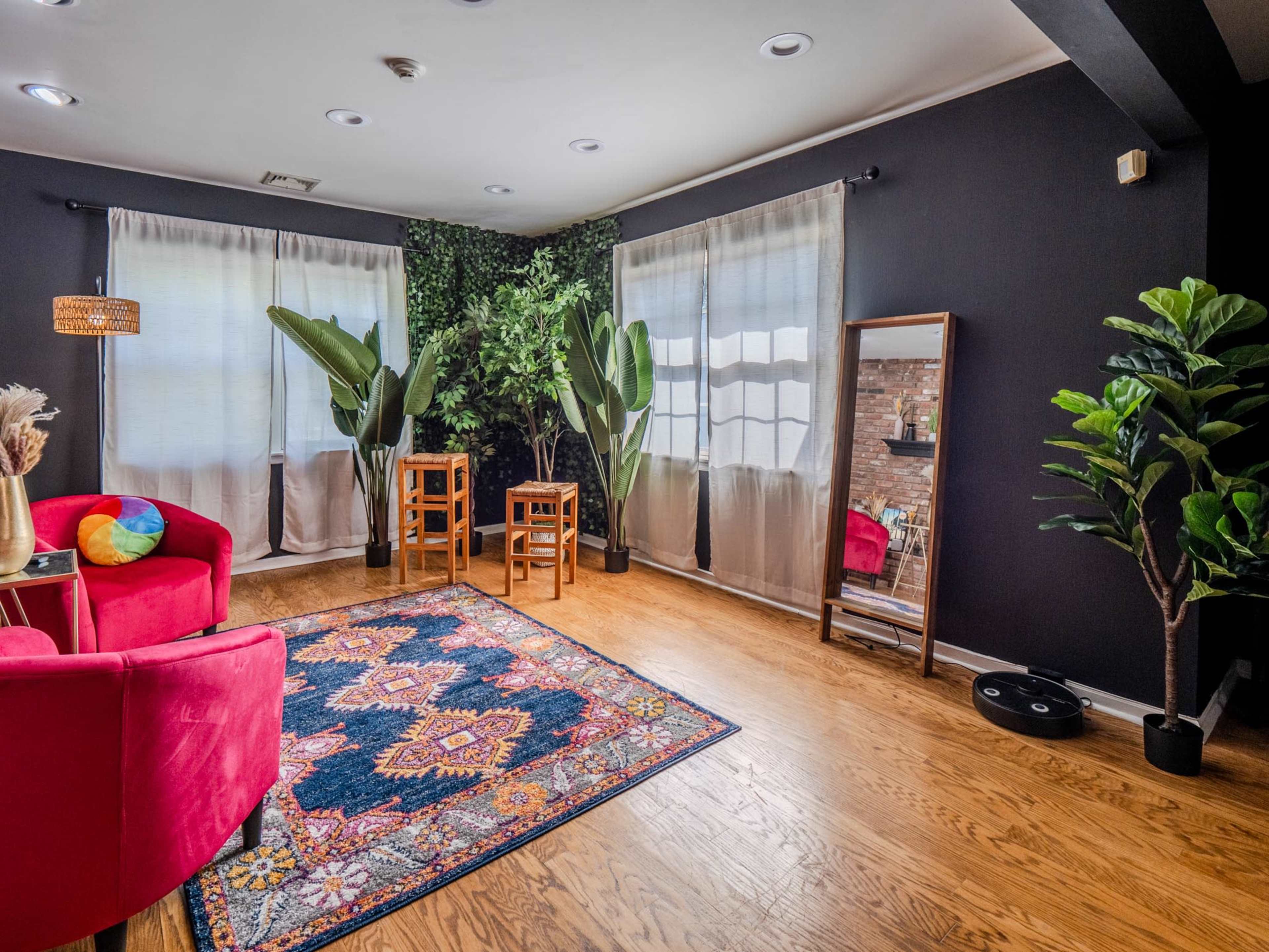 Bright lounge area with red chairs and natural light